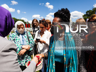 Rep. Sheila Jackson  Lee (D-TX) talks with people at a photo exhibition in memory of the thousands of  victims of Iran's 1988 massacre of po...