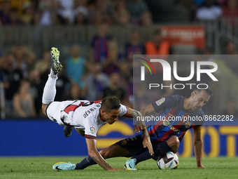 Sergio Busquets of Barcelona and Oscar Trejo Attacking Midfield of Rayo Vallecano and Argentina compete for the ball during the La Liga Sant...