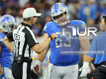 Referee Land Clark (130) talks with center Evan Brown (63) of the Detroit Lions during a break in play during an NFL preseason football game...
