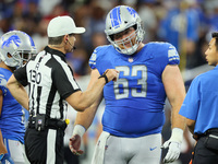Referee Land Clark (130) talks with center Evan Brown (63) of the Detroit Lions during a break in play during an NFL preseason football game...