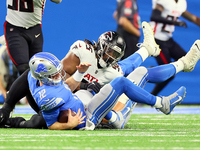 Quarterback Tim Boyle (12) of the Detroit Lions is stopped by defensive tackle Ta'Quon Graham (95) of the Atlanta Falcons during an NFL pres...