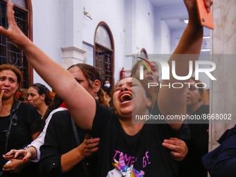 People react during the funeral of victims, who died due to the fire that broke out at the Abu Sifin church, inside the Church of the Blesse...