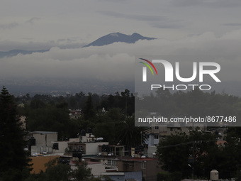 In the background, a panoramic view of the mountains in the Ajusco and Topilejo areas at dawn in Mexico City due to the monsoon that generat...