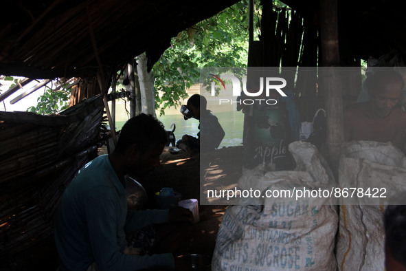 Low laying area people shelters on the way side after flood water entering into their living houses on the banks of Daya river outskirts of...