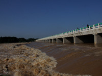 Low laying area people are seen as flood waters overflowing from the Daya river outskirts of the eastern Indian state Odisha's capital city...