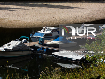 sevearl boats are seen resting on  on dried up partically river bank of ohbach rivver which direct connect to Rhine river during the low wat...