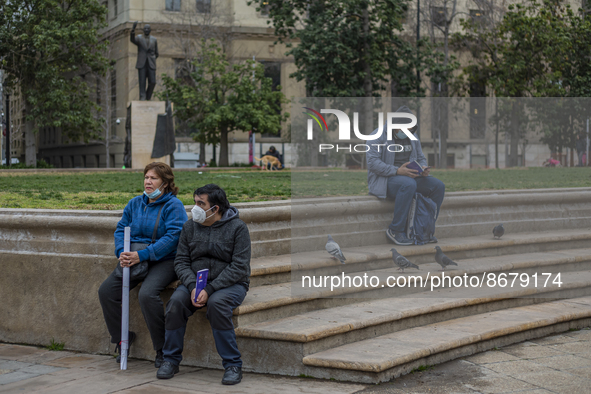 Persons rest and read the proposed of new constitution at La Plaza de la Constitución (courtyard of the government palace La Moneda), On  Au...