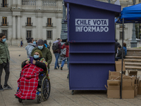 A disabled person takes a copy of the proposed of new constitution. From a kiosk that was installed by the government at La plaza de la cons...