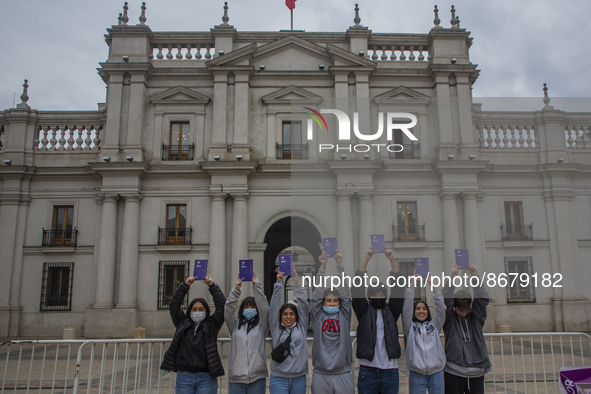 A group of young students pose holding up the proposed of new constitution in La Plaza de la Constitución (courtyard of the government palac...