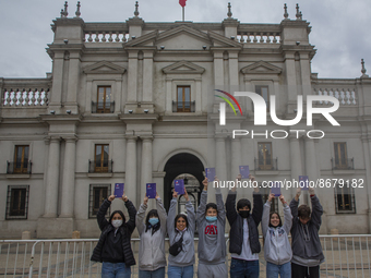 A group of young students pose holding up the proposed of new constitution in La Plaza de la Constitución (courtyard of the government palac...