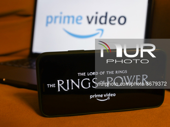 'The Lord of the Rings: The Rings of Power' series logo displayed on a phone screen Prime Video logo displayed on a laptop screen are seen i...