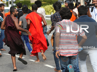 Protesters run as Sri Lankan Police disperse Protesters during the Inter-University Student Federation protest against the government of Pre...