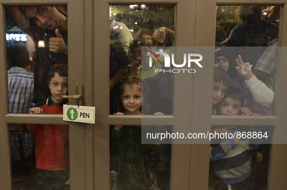 Refugees awaiting to enter to the Aspa Boomerang Restaurant, as the owner Michael Pastrikos, helped by his family members, his staff and man...