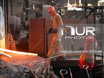 Laborers during work at a metal workshop at Postogola Area in Dhaka, Bangladesh on August 22, 2022.  (