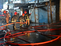 Firefighters try to extinguish a fire at a building at Bijoy Nagar in Dhaka, Bangladesh, on August 24, 2022.  (
