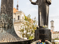 Two servicemen lie flowers under the statue of Taras Shevchenko, Ukrainian poet in the old town of Lviv as they celebrate Ukrainian Independ...