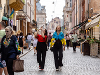 People walk on the streets at the Main Square 'Rynok' in the old town of Lviv as they celebrate Ukrainian Independence Day, as well as mark...