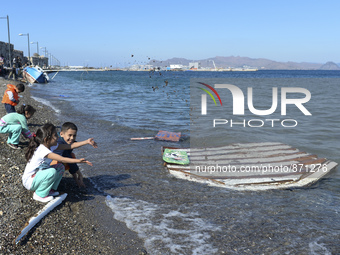 Children of migrants pictured playing in Kos harbour, as hundreds of new arrived migrants awaiting on a daily basis to be processed by the G...