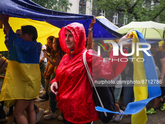 People walk on rain during a march on Independence Day of Ukraine in Krakow, Poland on  August 24, 2022. The day marks the 31st anniversary...
