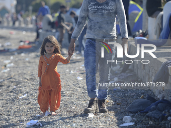A young Fariba (age 3) from Afganistan, pictured in Kos harbour when her family awaiting to be processed by the Greek police and given pape...