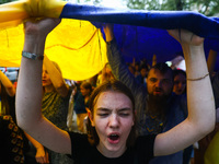 People walk on rain during a march on Independence Day of Ukraine in Krakow, Poland on  August 24, 2022. The day marks the 31st anniversary...