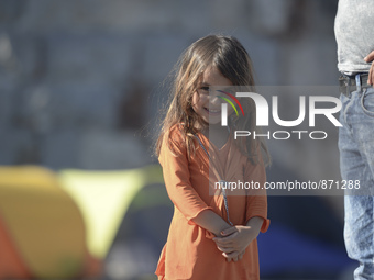 A young Fariba (age 3) from Afganistan pictured in Kos harbour, as her family awaiting to be processed by the Greek police and given paperwo...