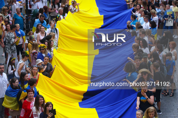 People carry a big Ukrainian flag during a demonstration on Independence Day of Ukraine in Krakow, Poland on  August 24, 2022. The day marks...
