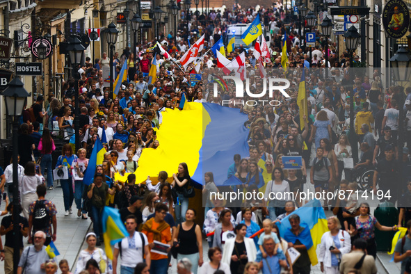 People carry a big Ukrainian flag during a demonstration on Independence Day of Ukraine in Krakow, Poland on  August 24, 2022. The day marks...