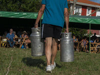 A participant in the race of pots, used to transport milk, are filled with water weighing 45 kilograms each and the winner is the one with t...