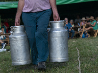Detail of one of the participants in the race of pots, used to transport milk, they are filled with water with a weight of 45 kilograms each...
