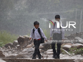School children head back home as rains lash in Poonch on Friday August 26, 2022 (