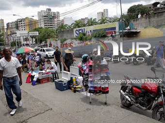 Passersby walk near a market in Caracas, Venezuela on August 28, 2022 (