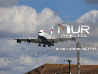 British Airways Airbus A380 airplane as seen on final approach flying over the houses in Myrtle Avenue, arriving for landing in London Heath...