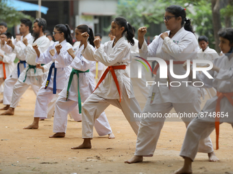 Students practice martial arts on the playground of a school in Dhaka, Bangladesh on August 30, 2022.  (