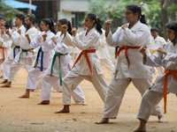 Students practice martial arts on the playground of a school in Dhaka, Bangladesh on August 30, 2022.  (