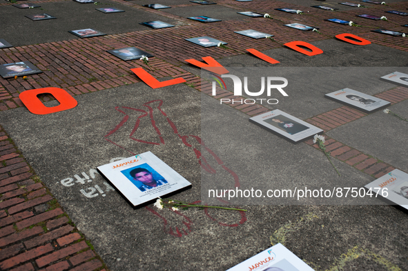 Photos of victims of enforced disapearances are seen with the word phrase 