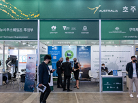 Visitors look at a exhibition booth displayed by Australia during the H2 MEET 2022 expo in KINTEX(Korea International Exhibition Center) on...
