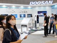 Visitors look at a exhibition booth displayed by DOOSAN  during the H2 MEET expo in KINTEX(Korea International Exhibition Center) on August...