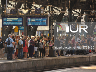 travellers are seen waiting at platform at Cologne central railway station in Cologne, Germany on Augut 31, 2022 (