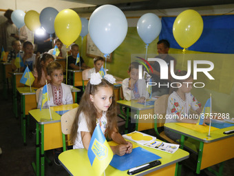 Ukrainian displaced children attend a patriotic lesson timed to the Knowledge Day for displaced children at a bomb shelter, in Odesa, Ukrain...
