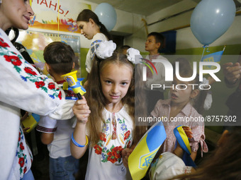 Ukrainian displaced children attend a patriotic lesson timed to the Knowledge Day for displaced children at a bomb shelter, in Odesa, Ukrain...
