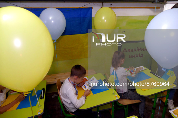 ODESA, UKRAINE - SEPTEMBER 1, 2022 - Children displaced by the war sit at the desks decorated with balloons in a bomb shelter during the Kno...