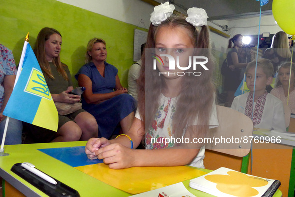 ODESA, UKRAINE - SEPTEMBER 1, 2022 - A girl in a vyshyvanka sits at the desk in a bomb shelter during a celebration organised by volunteers...