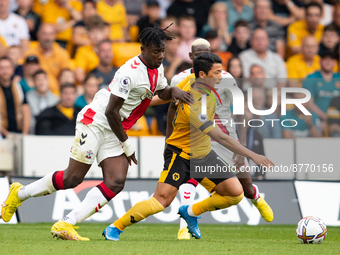 Mohammed Salisu of Southampton and Wolvess Hwang Hee-chan (R) during the Premier League match between Wolverhampton Wanderers and Southampto...