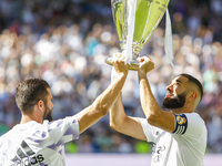 Nacho Fernandez of Real Madrid and Karim Benzema of Real Madrid showing the UEFA Champions League trophiy to their supporters during La Liga...