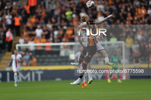 Hull City's Alfie Jones contests a header with Sheffield United's Oliver McBurnie during the Sky Bet Championship match between Hull City an...