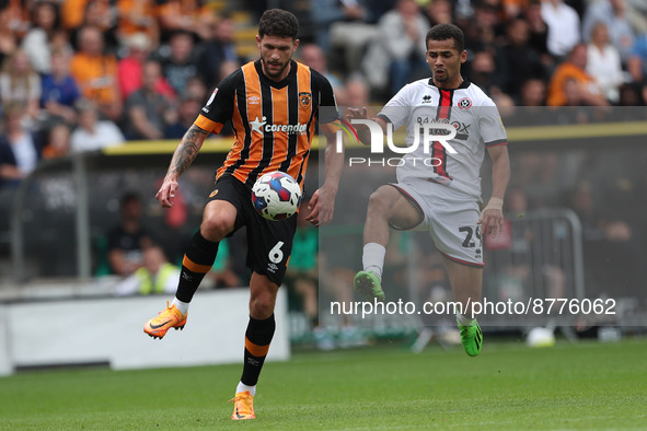 Tobias Figueiredo of Hull City in action with Sheffield United's Iliman Ndiaye during the Sky Bet Championship match between Hull City and S...