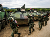 Taiwanese soldiers carrying artillery to tanks during the 2-day live-fire drill, amid intensifying threats military from China, in Pingtung...