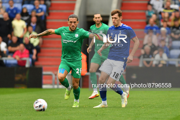 Darren Oldaker of Chesterfield Football Club tussles with Ben Tollitt of Oldham Athletic during the Vanarama National League match between O...