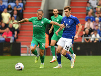 Darren Oldaker of Chesterfield Football Club tussles with Ben Tollitt of Oldham Athletic during the Vanarama National League match between O...